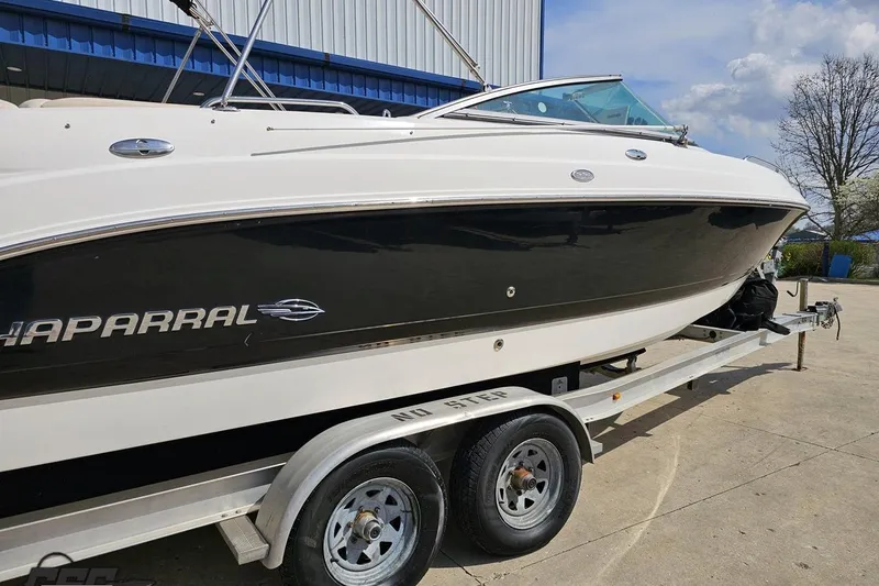 Slide: The Image of 2007 Chaparral 256 SSi boat on trailer, black and white exterior, parked outdoors. - 8