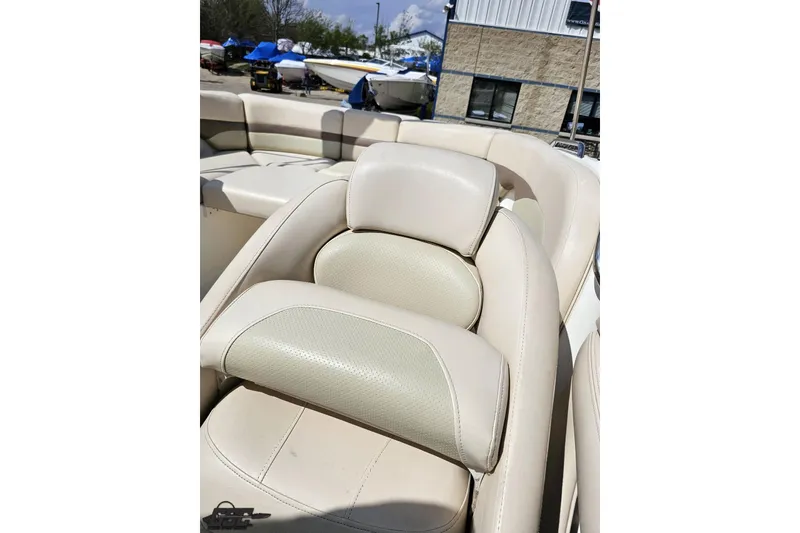 Slide: The Image of 2007 Chaparral 256 SSi boat with beige leather seating in a marina setting. - 82