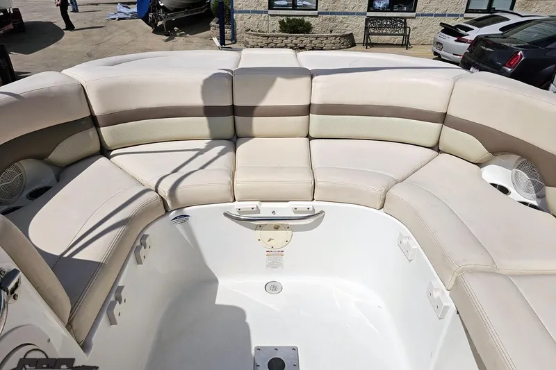 Slide: The Image of 2007 Chaparral 256 SSi boat interior with beige seating and spacious layout. - 87