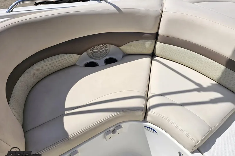 Slide: The Image of 2007 Chaparral 256 SSi boat interior with beige seating and cup holders. - 89