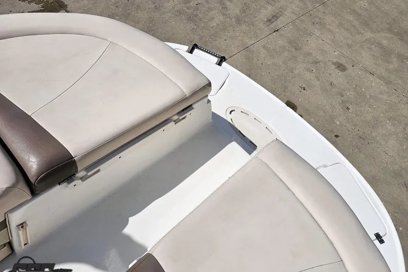 Slide: The Image of 2007 Chaparral 256 SSi boat seating area with beige upholstery and white deck. - 93