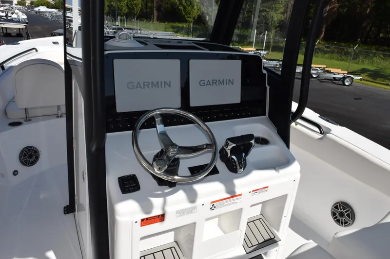 Slide: The Image of 2026 Sea Hunt Ultra 275 SE boat dashboard with dual Garmin displays and steering wheel. - 8