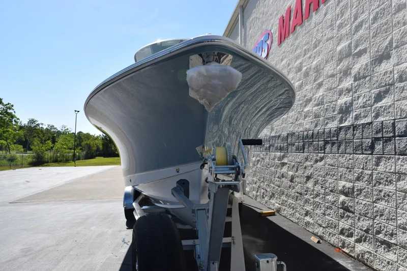 Slide: The Image of 2026 Sea Hunt Ultra 275 SE boat on trailer, parked beside a building. - 30