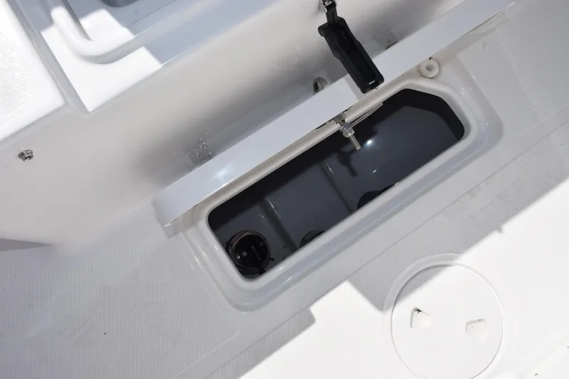 Slide: The Image of 2026 Sea Hunt Ultra 275 SE boat storage compartment, open and empty. - 27