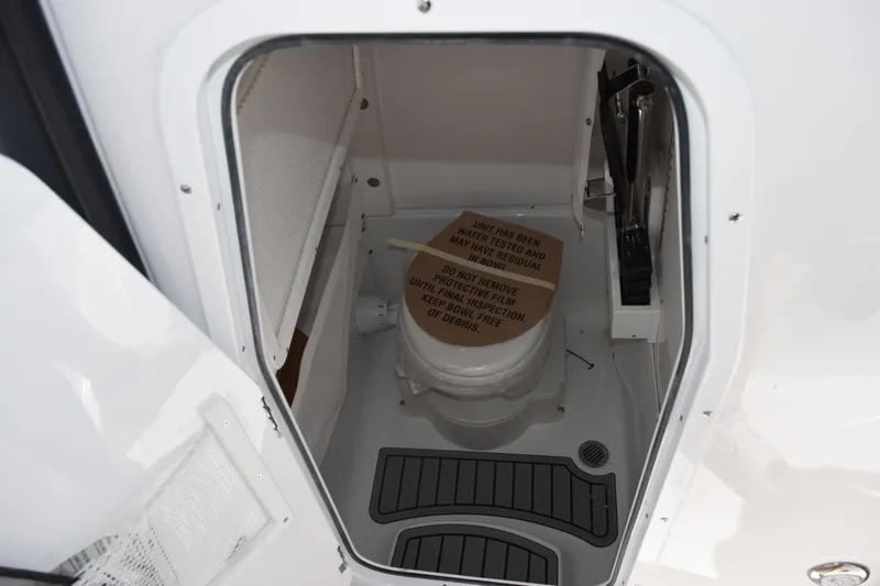 Slide: The Image of Interior view of 2026 Sea Hunt Ultra 275 SE boat compartment with toilet. - 14