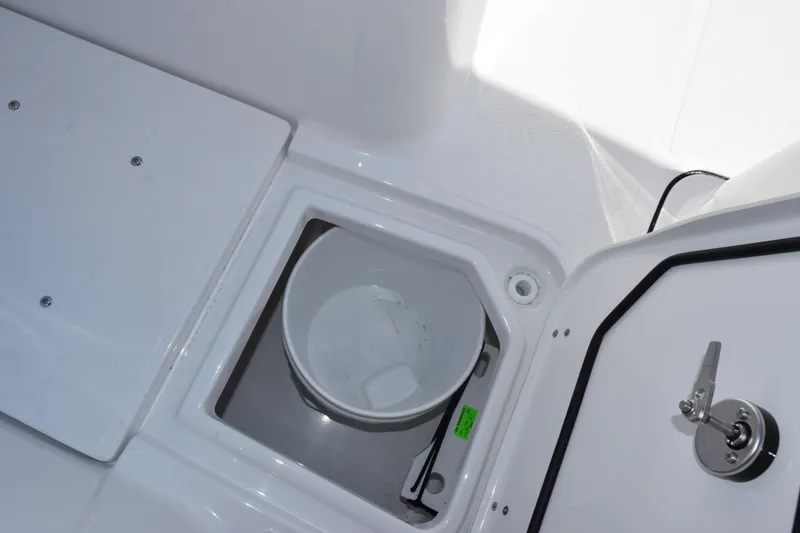 Slide: The Image of Storage compartment with bucket on 2026 Sea Hunt Ultra 275 SE boat. - 18