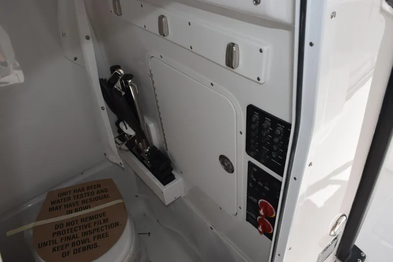 Slide: The Image of Interior view of 2026 Sea Hunt Ultra 275 SE boat with control panel and storage. - 16
