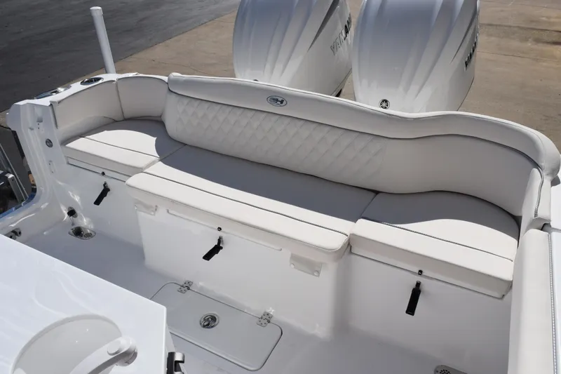 Slide: The Image of 2026 Sea Hunt Ultra 275 SE boat with white cushioned seating and dual engines. - 6