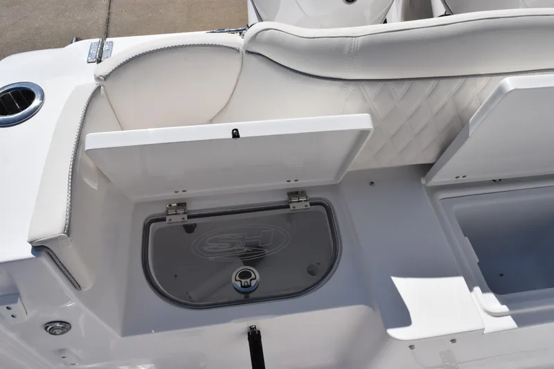 Slide: The Image of 2026 Sea Hunt Ultra 275 SE boat interior with storage compartments and cushioned seating. - 26