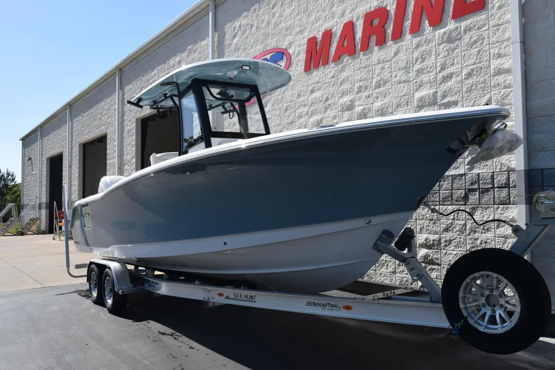Slide: The Image of 2026 Sea Hunt Ultra 275 SE boat on trailer outside marine dealership. - 29