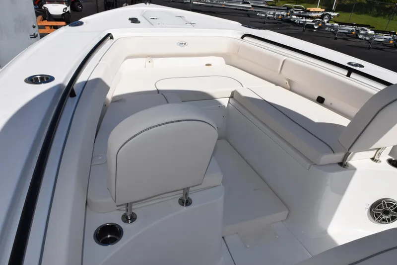 Slide: The Image of 2026 Sea Hunt Ultra 275 SE boat interior with white seating and cup holders. - 11