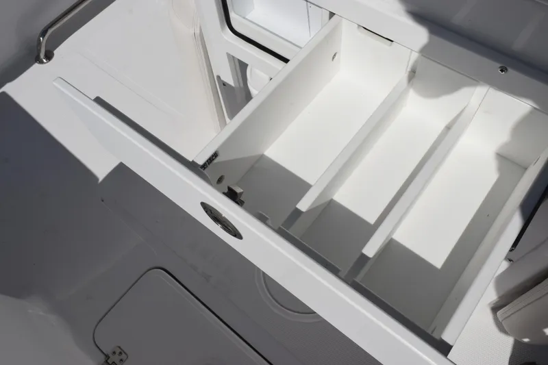 Slide: The Image of Storage compartment on 2026 Sea Hunt Ultra 275 SE boat, featuring organized interior space. - 23