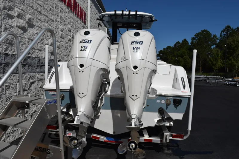 Slide: The Image of 2026 Sea Hunt Ultra 275 SE boat with dual 250 V6 engines, parked outdoors. - 5