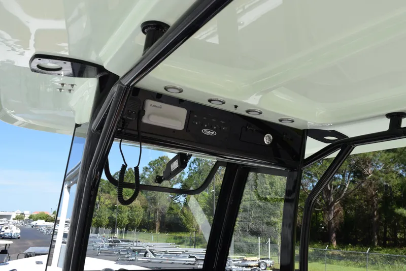 Slide: The Image of Interior view of 2026 Sea Hunt Ultra 265 SE boat's control panel and structure. - 11