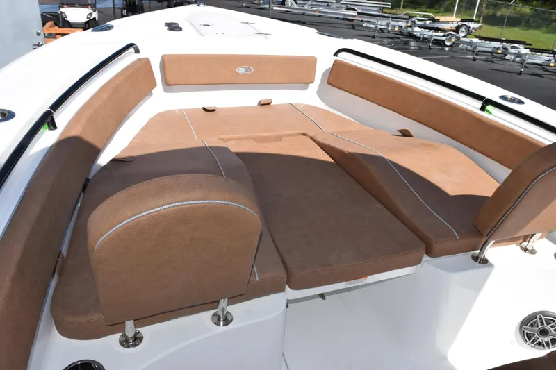 Slide: The Image of 2026 Sea Hunt Ultra 265 SE boat with spacious brown cushioned seating area. - 12