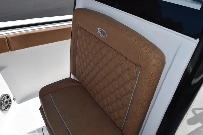 Slide: The Image of Luxurious brown seat on 2026 Sea Hunt Ultra 265 SE boat, featuring diamond stitching. - 13