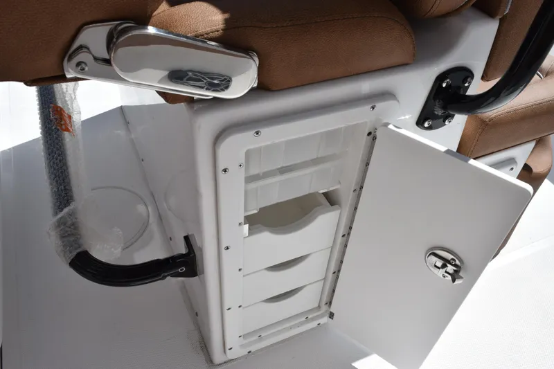 Slide: The Image of Storage compartment on 2026 Sea Hunt Ultra 265 SE boat with open door and seating. - 20