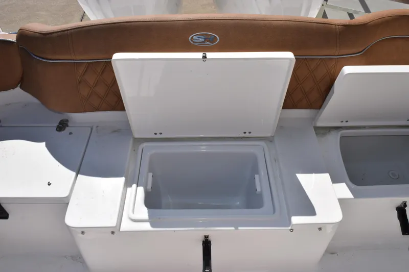 Slide: The Image of 2026 Sea Hunt Ultra 265 SE boat with open storage compartments. - 24