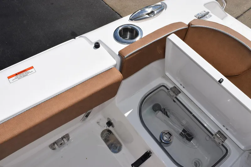 Slide: The Image of 2026 Sea Hunt Ultra 265 SE boat interior with storage compartment and cup holder. - 25