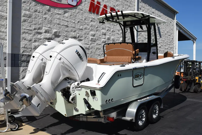 Slide: The Image of 2026 Sea Hunt Ultra 265 SE boat with twin Yamaha engines on a trailer. - 4
