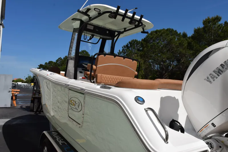 Slide: The Image of 2026 Sea Hunt Ultra 265 SE boat with Yamaha engine, parked outdoors. - 6