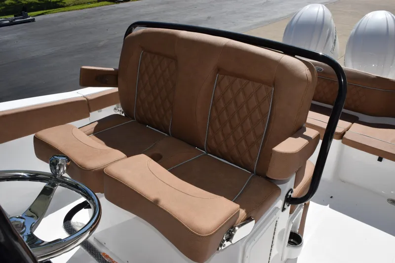 Slide: The Image of 2026 Sea Hunt Ultra 265 SE boat with luxurious brown seating and dual engines. - 7