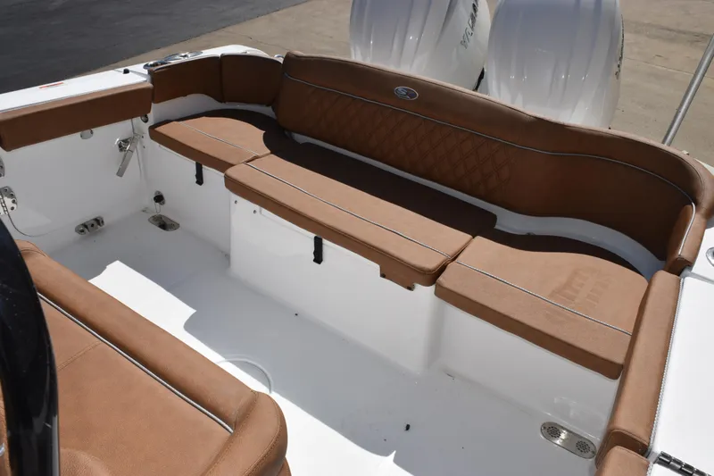 Slide: The Image of 2026 Sea Hunt Ultra 265 SE boat interior with brown cushioned seating. - 8