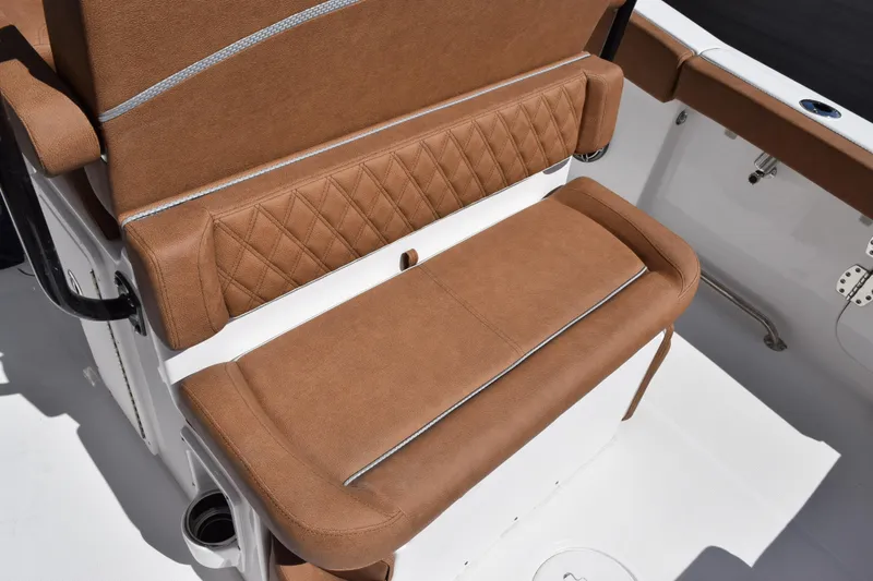 Slide: The Image of 2026 Sea Hunt Ultra 265 SE boat seat with brown cushioned upholstery and diamond stitching. - 9