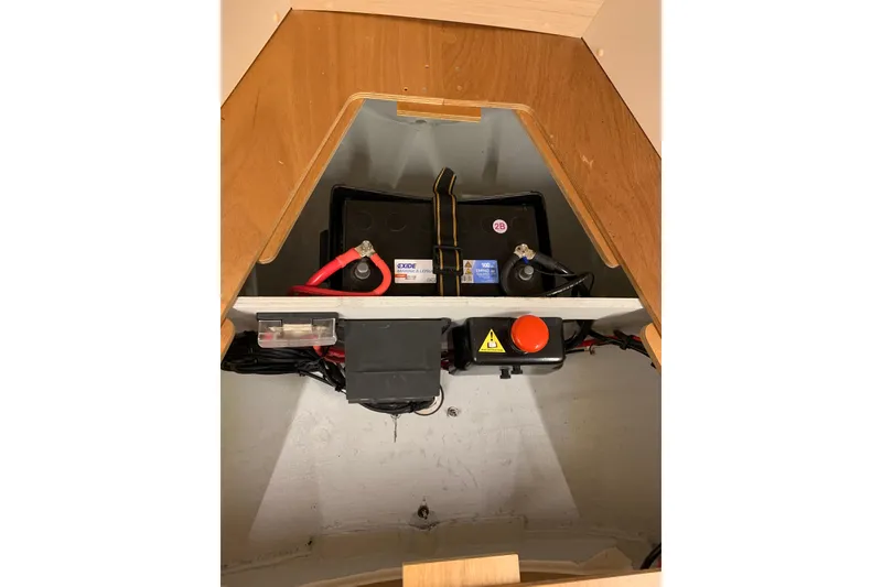 Slide: The Image of Battery compartment of 2023 Beneteau Oceanis 34.1 sailboat, featuring Exide battery setup. - 13