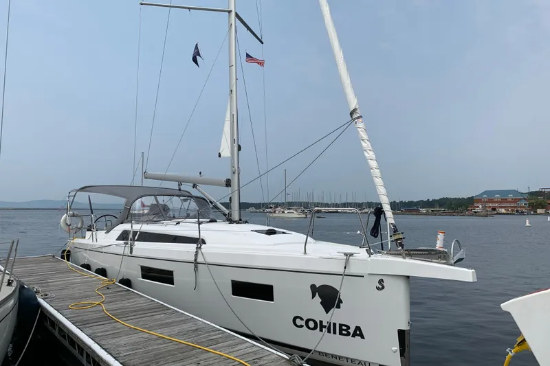 Slide: The Image of 2023 Beneteau Oceanis 34.1 sailboat docked at marina, featuring sleek design and modern amenities. - 2