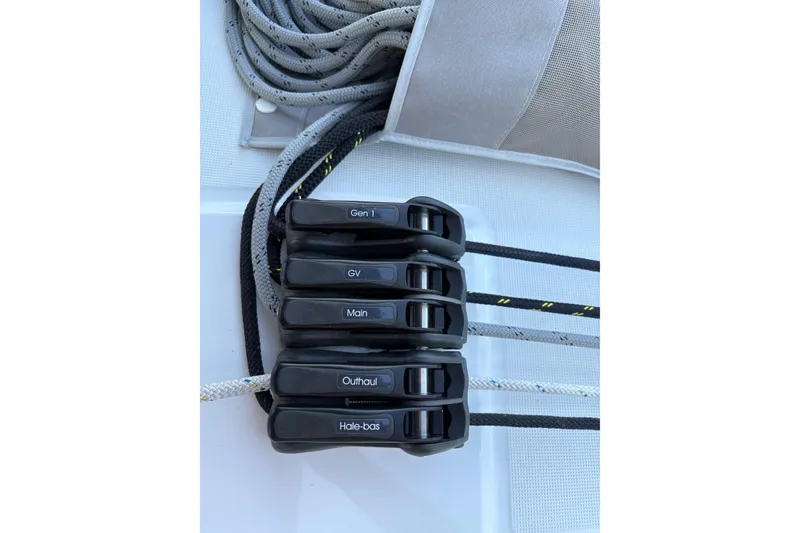 Slide: The Image of Rope clutches on 2023 Beneteau Oceanis 34.1 sailboat deck, labeled for sail control. - 22
