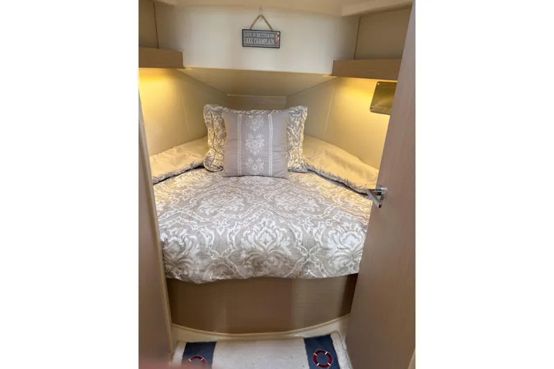 Slide: The Image of Cozy cabin interior of 2023 Beneteau Oceanis 34.1 with elegant bedding and soft lighting. - 27