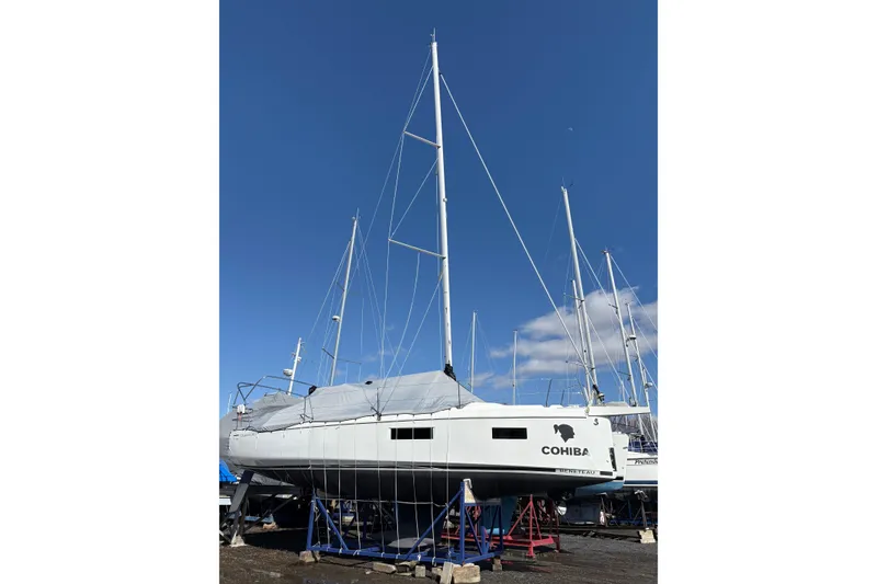 Slide: The Image of 2023 Beneteau Oceanis 34.1 sailboat on stands under clear blue sky. - 5