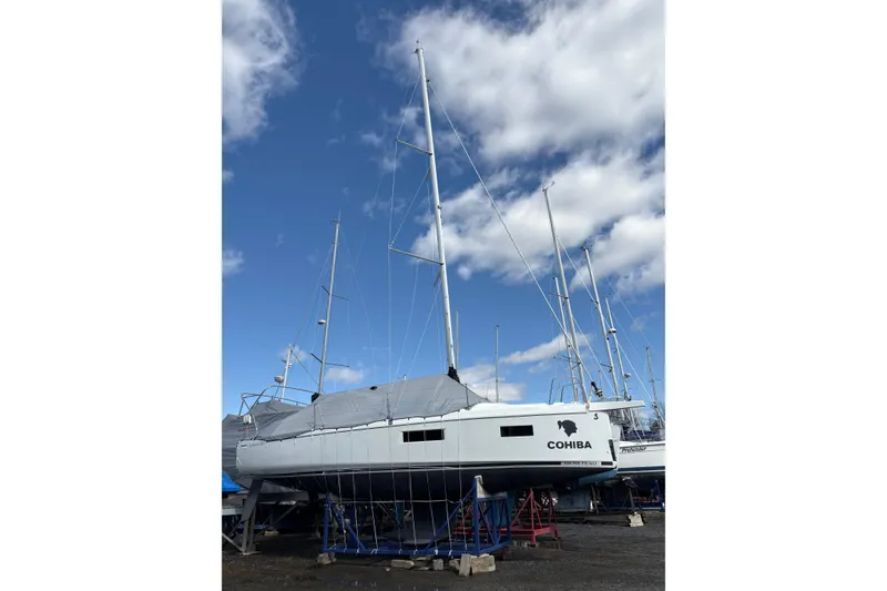Slide: The Image of 2023 Beneteau Oceanis 34.1 sailboat on dry dock under a blue sky. - 7