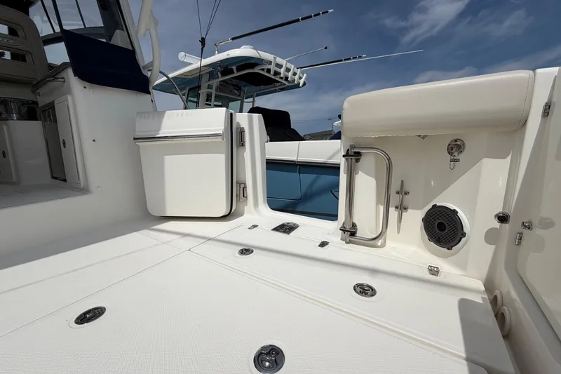 Slide: The Image of 2023 Boston Whaler 325 Conquest boat deck with storage and fishing rod holders. - 12