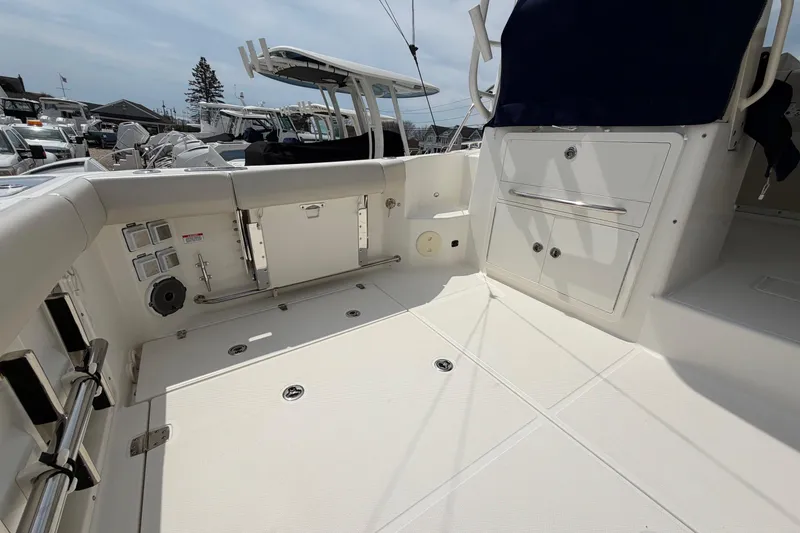 Slide: The Image of 2023 Boston Whaler 325 Conquest boat deck with storage compartments and seating. - 13
