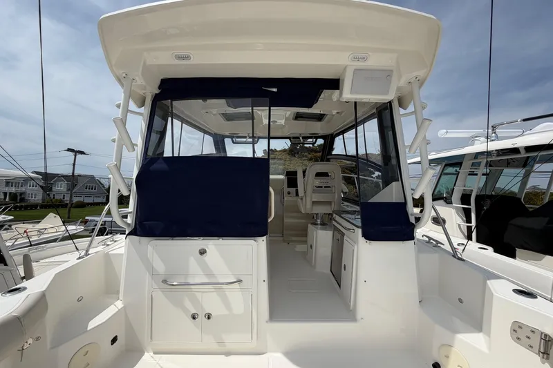 Slide: The Image of 2023 Boston Whaler 325 Conquest boat interior with seating and helm station. - 14