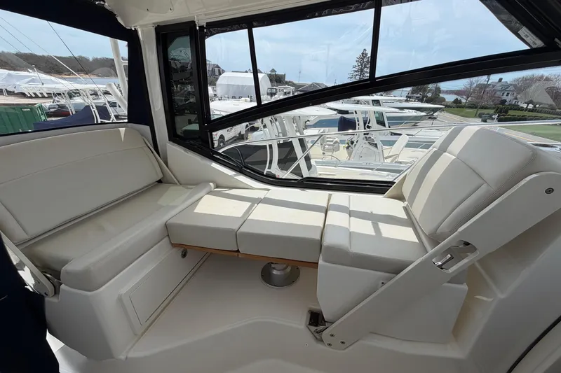 Slide: The Image of Interior seating of 2023 Boston Whaler 325 Conquest boat, featuring comfortable white cushions. - 18