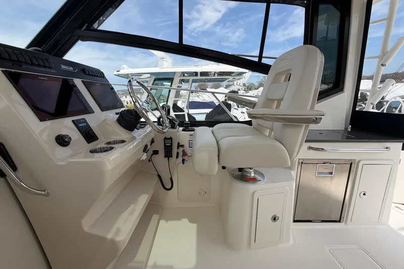 Slide: The Image of 2023 Boston Whaler 325 Conquest helm with modern controls and comfortable seating. - 20