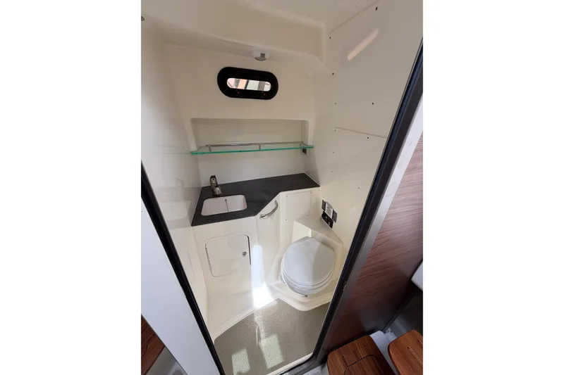 Slide: The Image of Interior of 2023 Boston Whaler 325 Conquest boat bathroom with sink and toilet. - 30