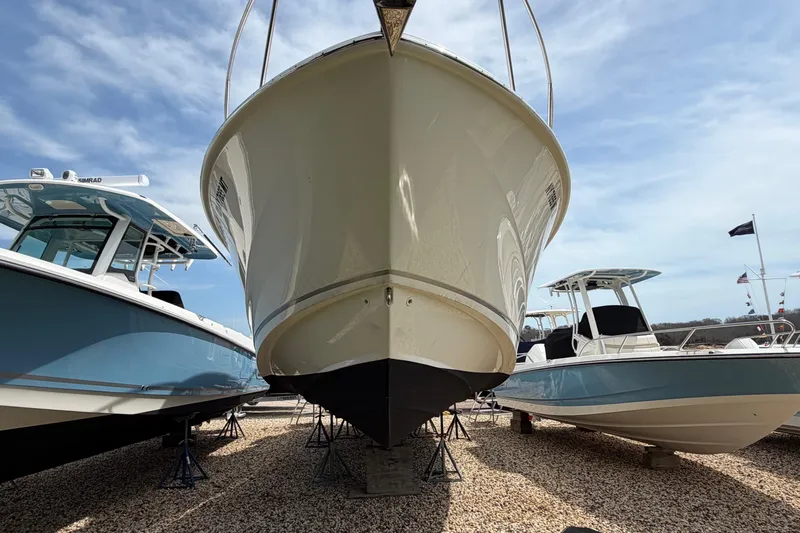 Slide: The Image of 2023 Boston Whaler 325 Conquest boat displayed outdoors on gravel. - 37