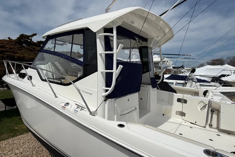Slide: The Image of 2023 Boston Whaler 325 Conquest boat, featuring sleek design and spacious deck. - 39