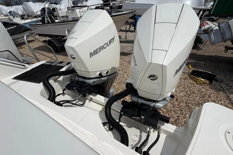 Slide: The Image of Twin Mercury outboard engines on a 2023 Boston Whaler 325 Conquest boat. - 7