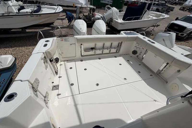 Slide: The Image of 2023 Boston Whaler 325 Conquest boat deck with spacious layout and storage compartments. - 9