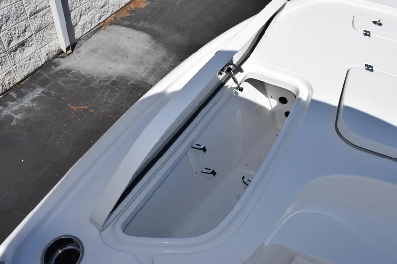 Slide: The Image of 2026 Sea Hunt BX 22 BR boat storage compartment, open on a sunny day. - 13