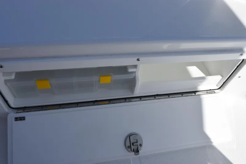 Slide: The Image of Storage compartment on 2026 Sea Hunt BX 22 BR boat, featuring organized tackle boxes. - 15