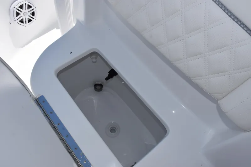 Slide: The Image of Storage compartment on 2026 Sea Hunt BX 22 BR boat with quilted seating. - 16