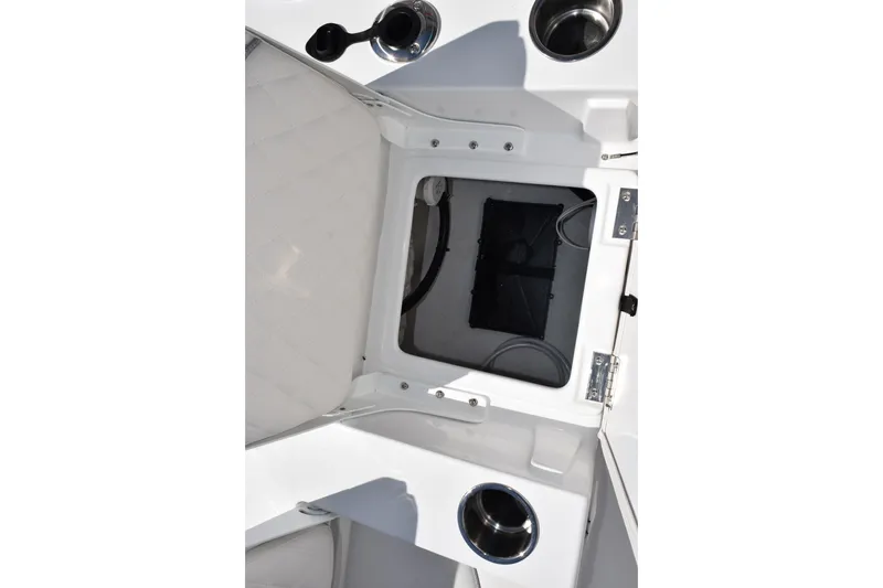 Slide: The Image of 2026 Sea Hunt BX 22 BR boat storage compartment with cup holders and white interior. - 19