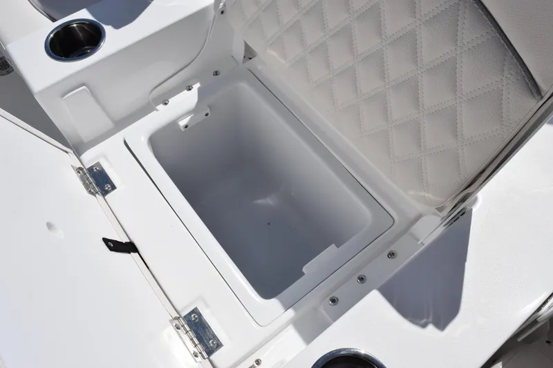 Slide: The Image of Open storage compartment on 2026 Sea Hunt BX 22 BR boat with cushioned seating. - 20