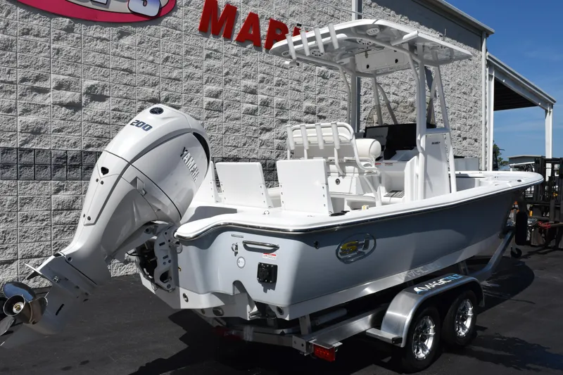 Slide: The Image of 2026 Sea Hunt BX 22 BR boat with Yamaha engine on trailer, parked outdoors. - 4